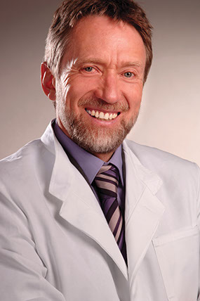 Dr. Gottfried Lange in white coat.